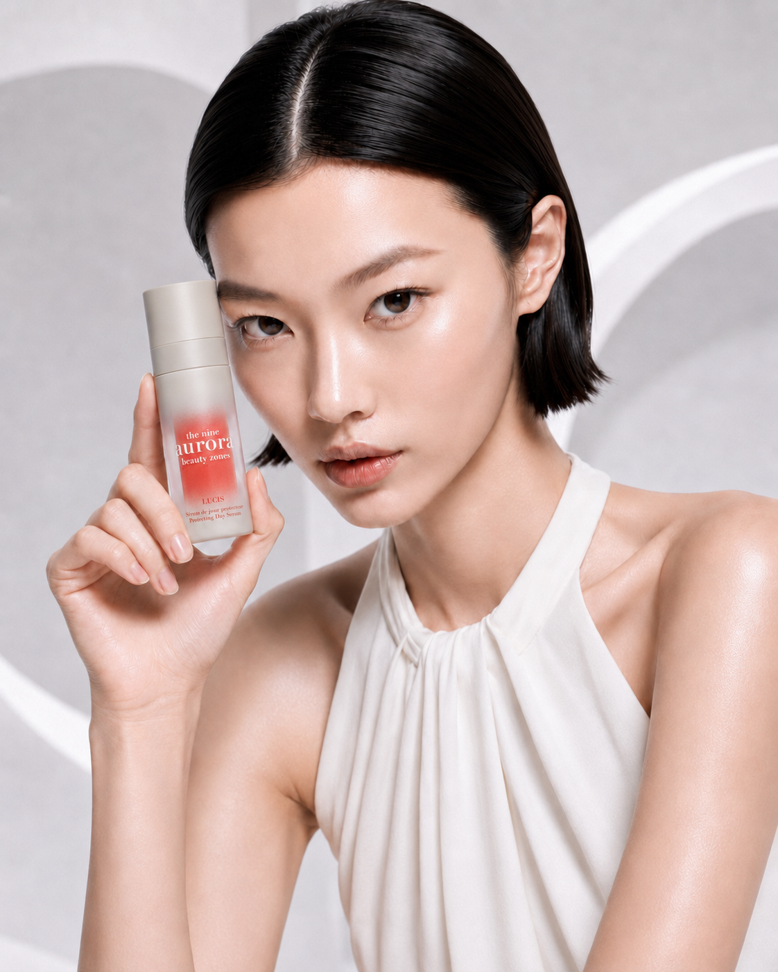 Japanese model holding Lucis Protecting Day Serum for hydration, radiance, antioxidant protection and skin barrier support.