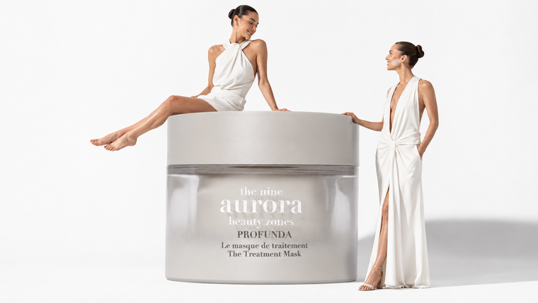 Model carrying an oversized The Nine Aurora Profunda The Treatment Mask jar on a pure white background